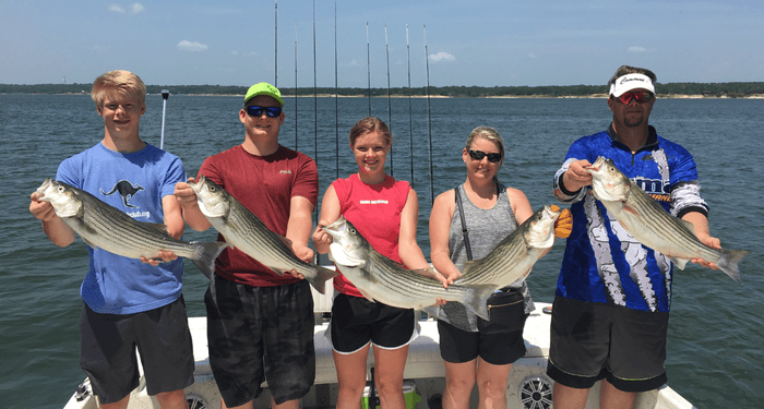 Lake Texoma Fishing Guides Customers with summertime striper